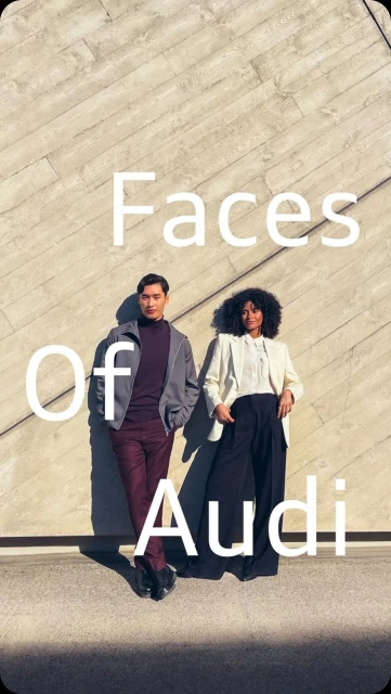 Two people, an Asian male and a Black female, pose in front of a textured concrete wall for an automotive advertisement. The image features natural light.