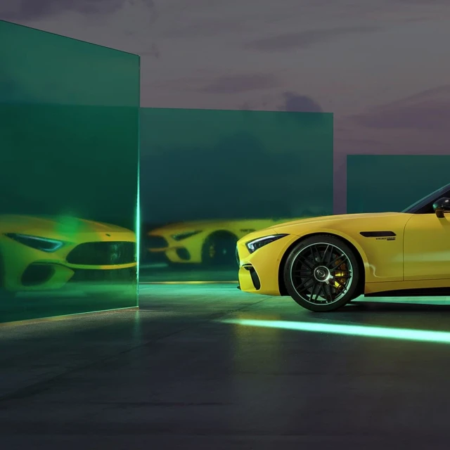 Two yellow Mercedes-AMG cars are displayed in an automotive studio with a creative lighting design and modern aesthetic.