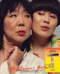 Close-up portrait of two East Asian women with dark hair and neutral expressions against a grey backdrop, photographed by Delali Ayivi.