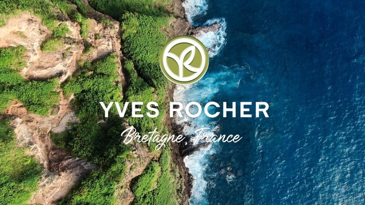 Aerial view of Yves Rocher brand logo over ocean and coastline in Bretagne, France, promoting beauty and nature.
