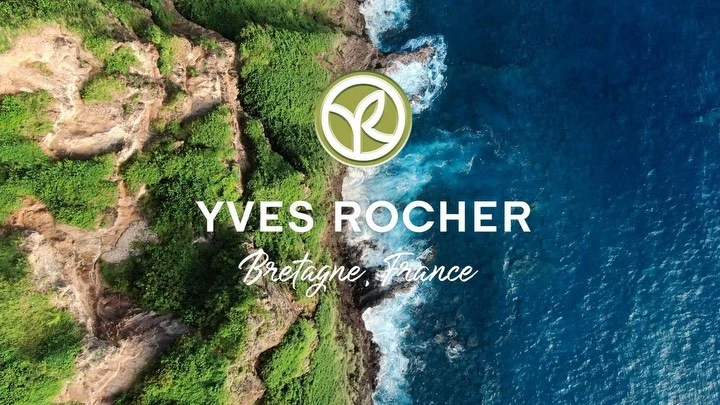 Aerial view of Yves Rocher brand logo over ocean and coastline in Bretagne, France, promoting beauty and nature.
