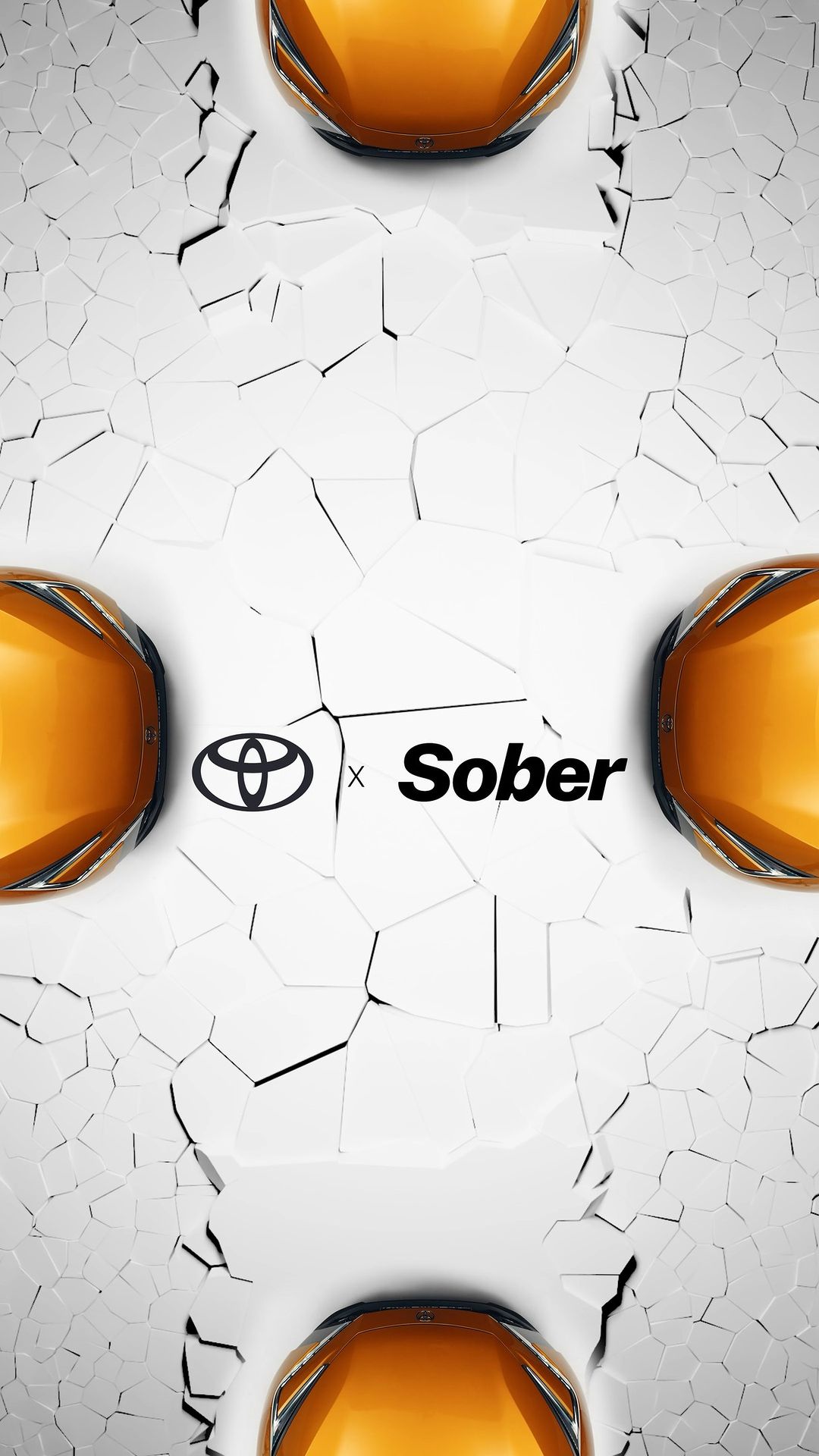 Close-up of three orange Toyota cars against a cracked white surface with the Toyota and Sober logos prominently displayed in the center.