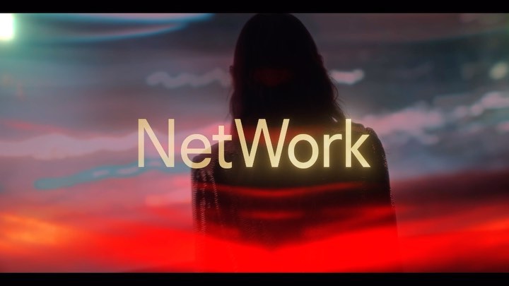 Silhouetted person stands in front of an atmospheric sunset sky with the word 'NetWork' overlaid on the image.