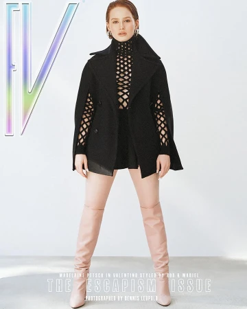 Fashion magazine cover featuring a woman in a black top, black cape jacket, and high boots against a white background.