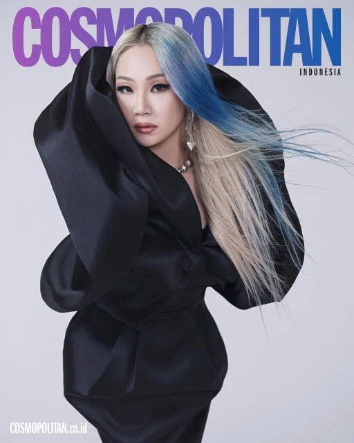 Cosmopolitan Indonesia cover featuring a woman in a large black dress with a striking blue-ombre hairstyle, striking a bold pose.