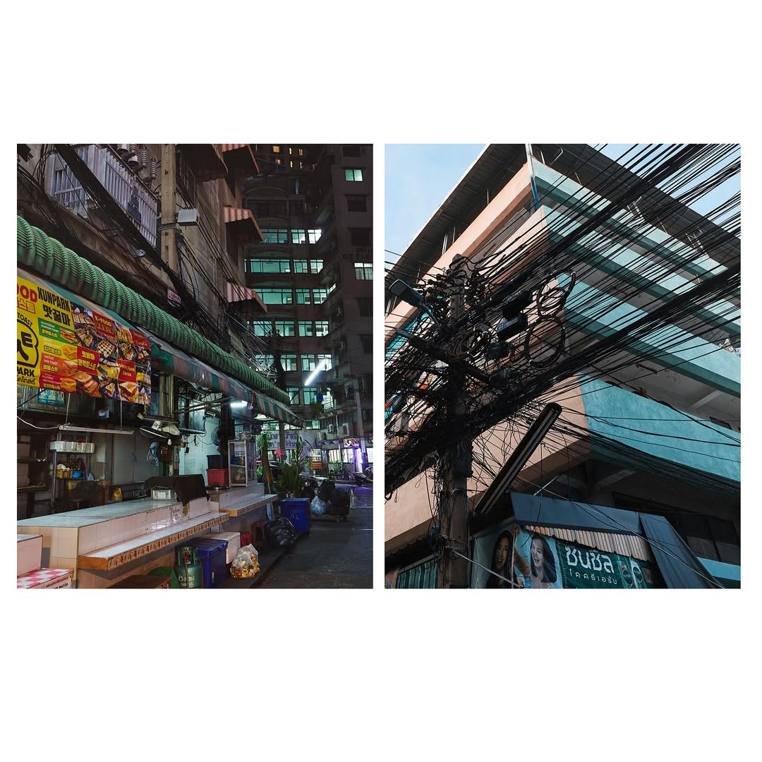 Urban scene featuring a street market stall and a pole with chaotic electric wires, capturing the essence of a bustling city at night.