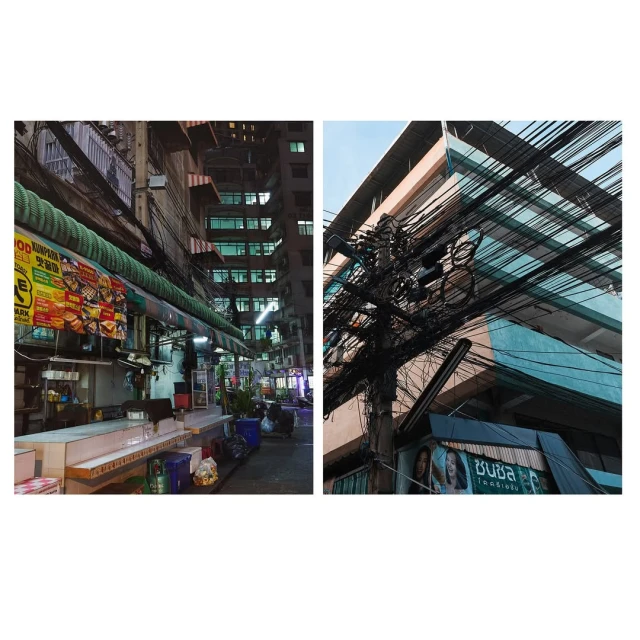 Urban scene featuring a street market stall and a pole with chaotic electric wires, capturing the essence of a bustling city at night.