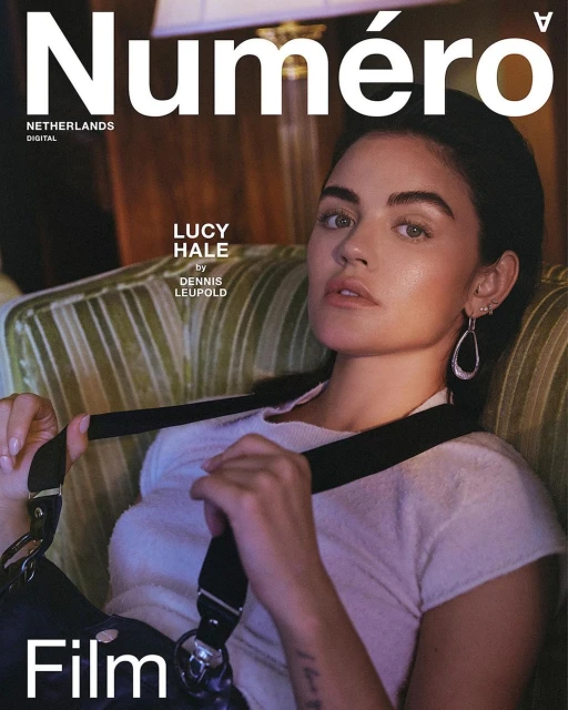 Portrait of Lucy Hale on Numero Netherlands cover with dark hair and teardrop earrings, wearing a light sweater and black shoulder bag.