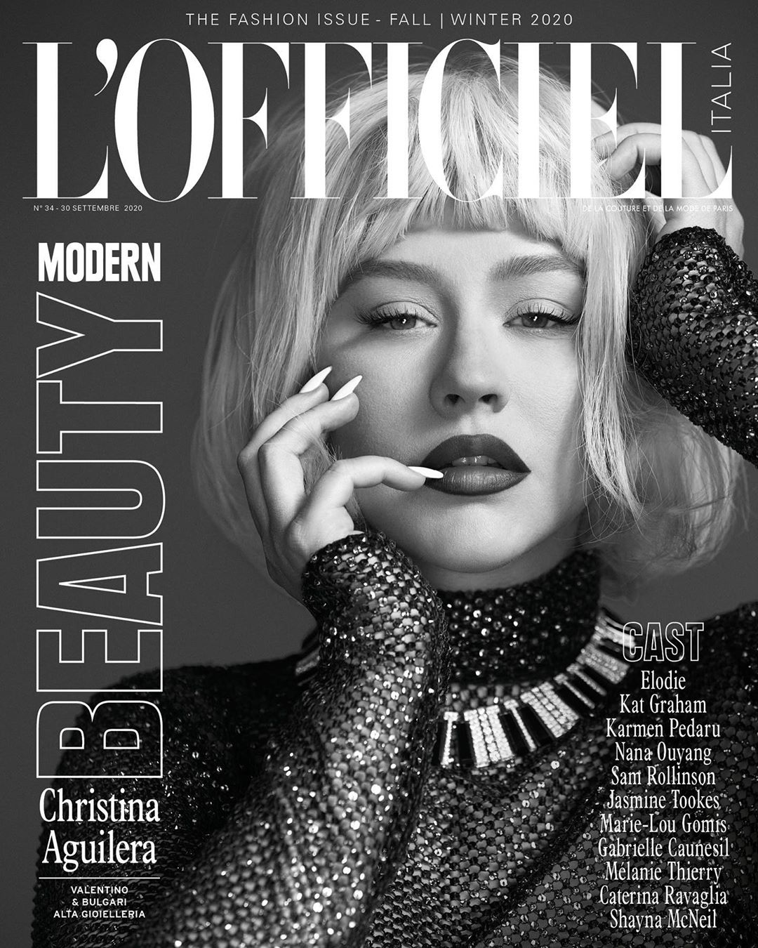 Black-and-white close-up magazine cover featuring Christina Aguilera with platinum blond hair, full makeup, and a sequined top with jewelry.