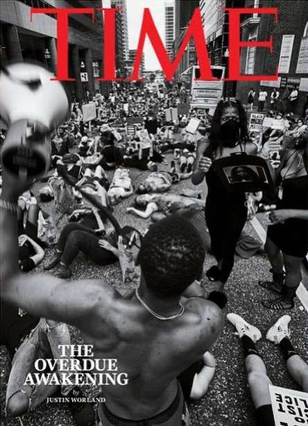 TIME magazine cover with a monochromatic photo of a large crowd of people protesting in a city street with 'TIME' in red lettering.