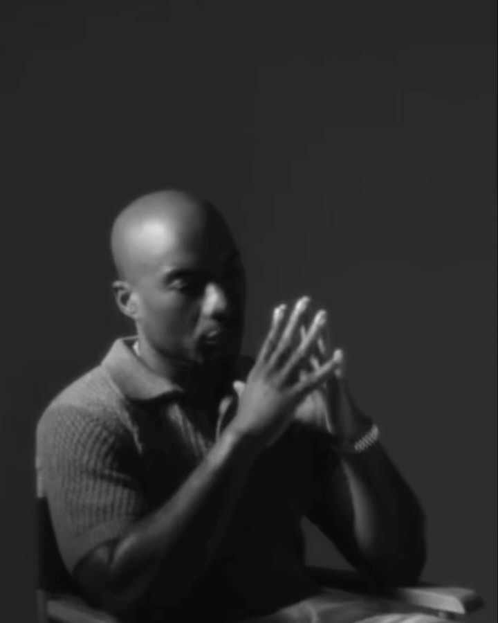 Black and white portrait of a bald man seated with hands clasped by photographer Devin Yalkin in New York