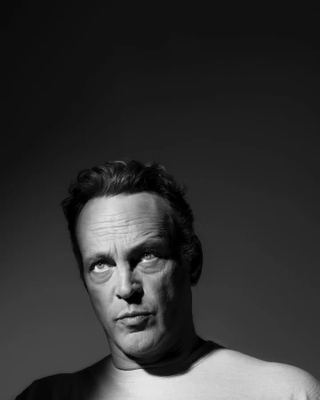 Monochrome portrait of Vince Vaughn looking upward in low-key lighting by photographer Devin Yalkin in New York