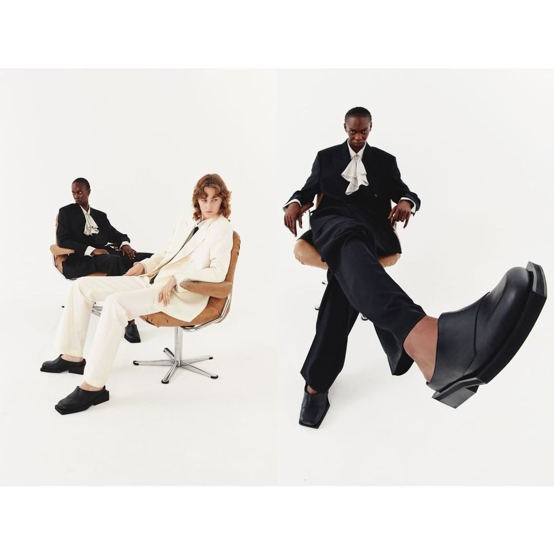 Two models seated in wheeled office chairs against a plain white background, photographed by Diane Sagnier in Paris.