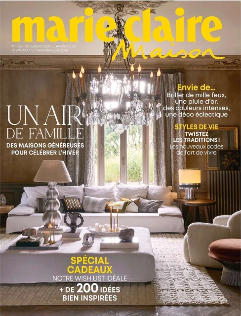 Marie Claire Maison magazine cover featuring a living room interior with a chandelier, sofa, coffee table, and soft, natural light.