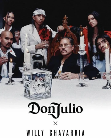 Group of adults gathered around a table with a Don Julio tequila bottle and candles, shot in a dimly lit indoor setting.