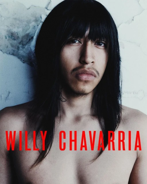 Portrait of a bare-chested adult male with long, dark hair against a textured white wall, featuring the text 'WILLY CHAVARRIA'.