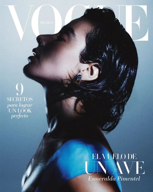 Vogue Mexico cover featuring Esmeralda Pimentel in profile with short dark hair, blue shoulder wrap, and earring, set against a gradient blue background.