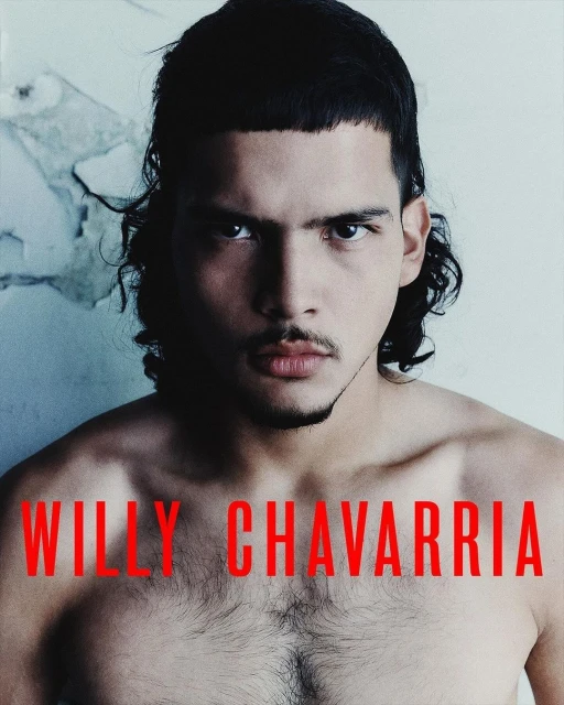 Portrait of a shirtless adult male with dark hair and a serious expression, against a textured off-white background and red text overlay.