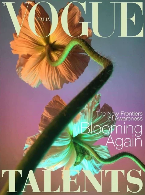 Vogue Italia magazine cover featuring blooms in peach and white hues with green stems, set against a purple and teal gradient background.