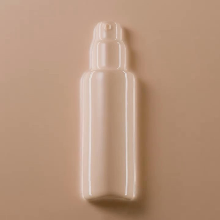 Close-up studio shot of a beige bottle with a pump dispenser, set against a matching beige background for beauty product promotion.