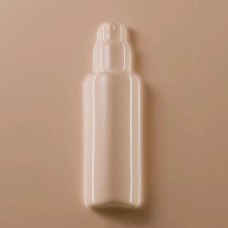 Close-up studio shot of a beige bottle with a pump dispenser, set against a matching beige background for beauty product promotion.