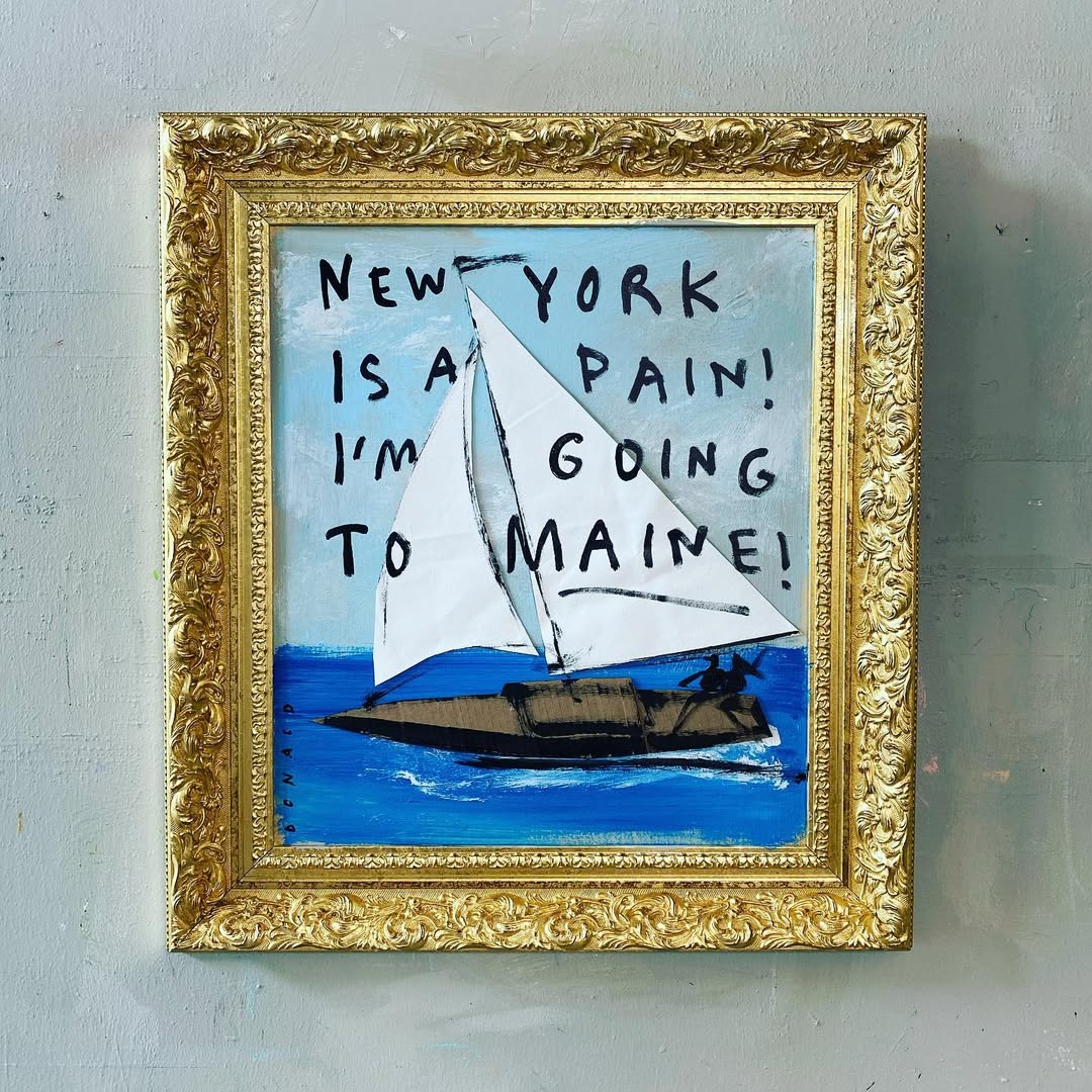 Painting of sailboat on blue water, in gold frame, with painted text 'New York is a pain! I'm going to Maine!' artwork.
