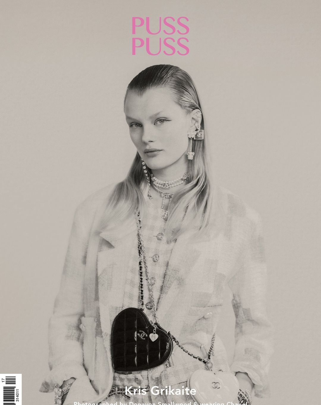 Magazine cover featuring a model with blonde hair, wearing a Chanel jacket and heart-shaped purse, posing indoors.