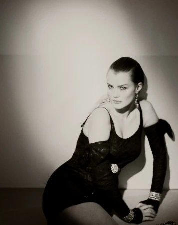 Portrait of a woman wearing a black dress and long gloves, photographed by Donavon Smallwood.