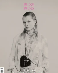 Model Kris Grikaite wearing tweed jacket and layered pearl necklaces against a neutral background