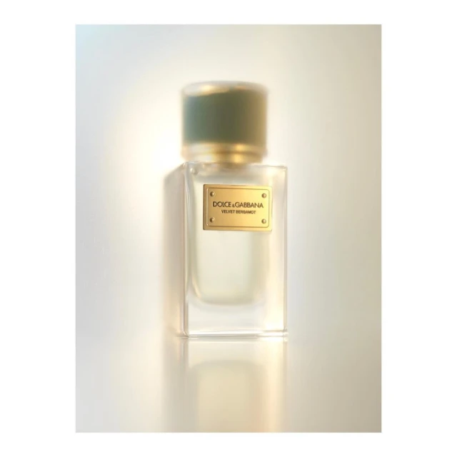 Dolce & Gabbana Velvet Bergamot perfume bottle on a soft white surface, showcasing the brand's elegant fragrance and packaging design.