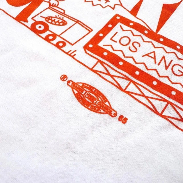 Retro-style graphic illustration with 'Los Angeles' text, featuring cartoon figures and design elements in a bold, orange color scheme.