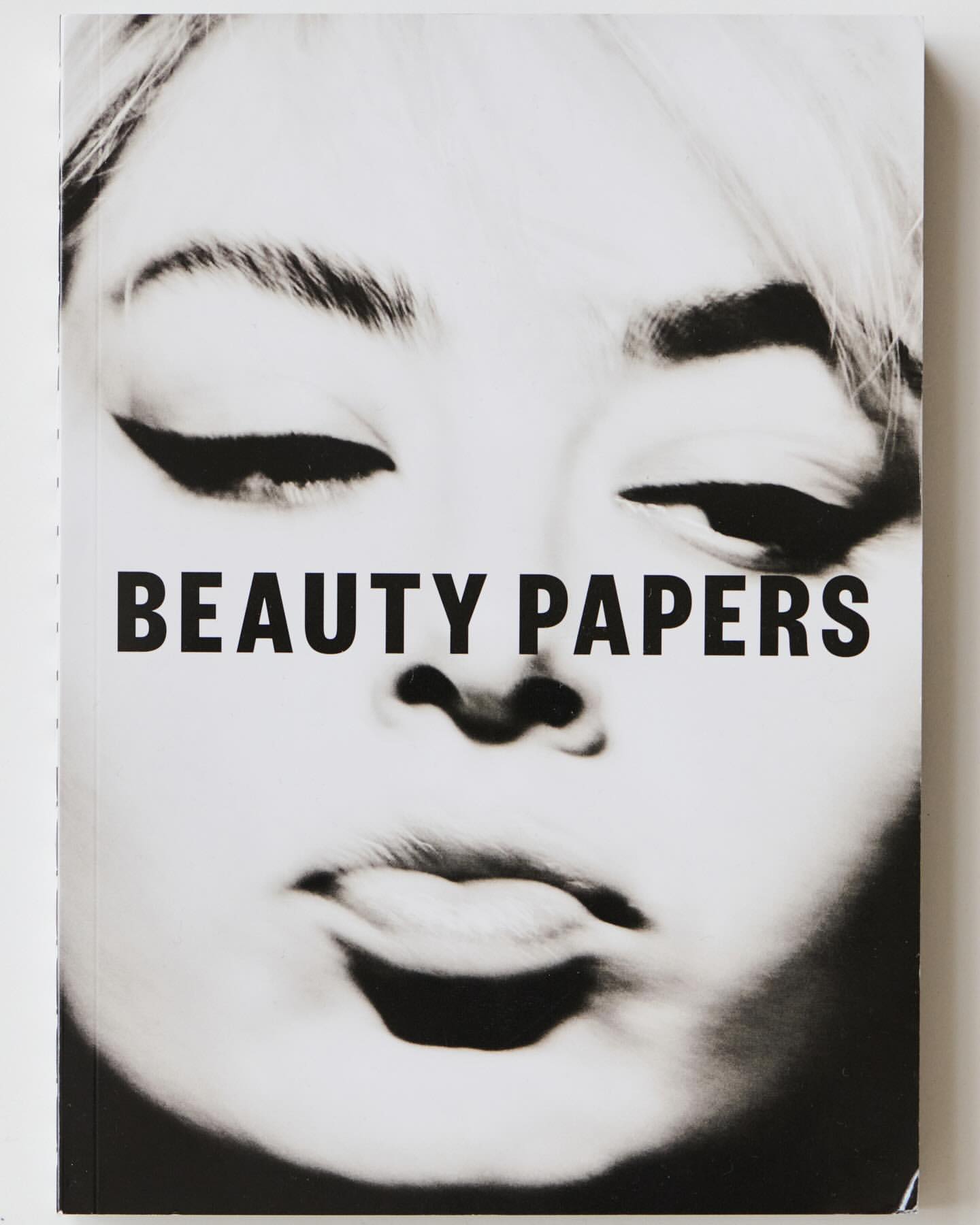 Black and white book cover with a beauty theme featuring a face and bold sans-serif typography, 'BEAUTY PAPERS'.