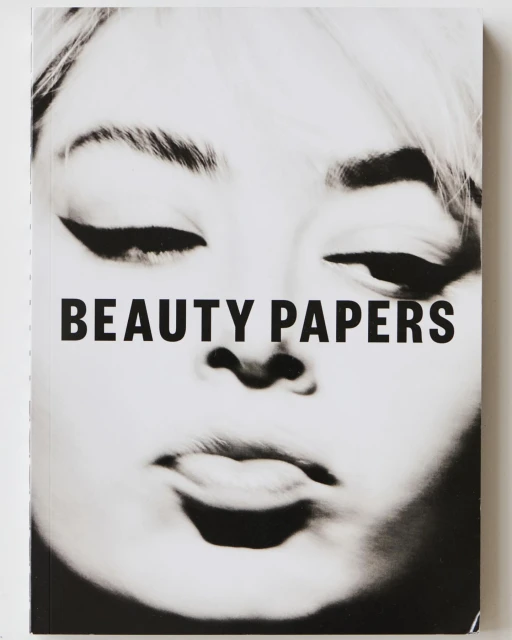 Black and white book cover with a beauty theme featuring a face and bold sans-serif typography, 'BEAUTY PAPERS'.