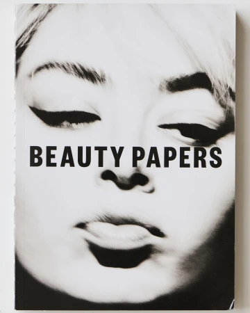 Black and white book cover with a beauty theme featuring a face and bold sans-serif typography, 'BEAUTY PAPERS'.