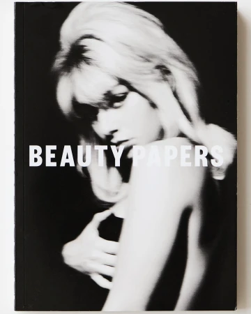 Monochrome magazine cover featuring a woman with voluminous blonde hair and bold typography reading BEAUTY PAPERS.