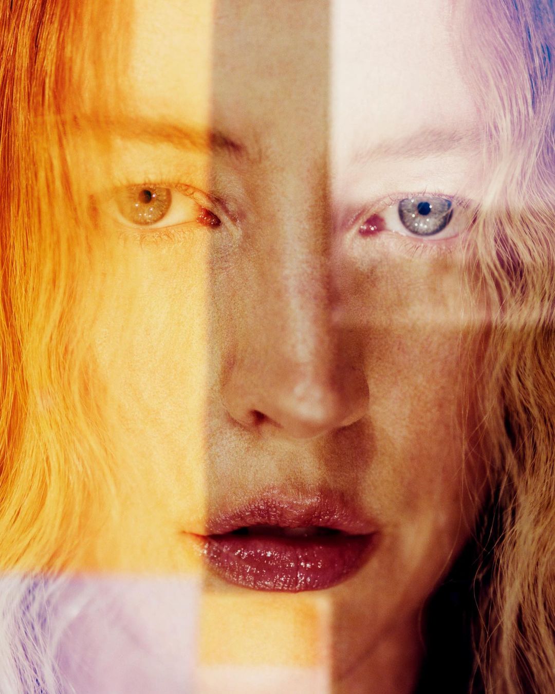 Artistic portrait of a woman with striking heterochromia, featuring one blue eye and one green eye, enhanced by colorful lighting effects.