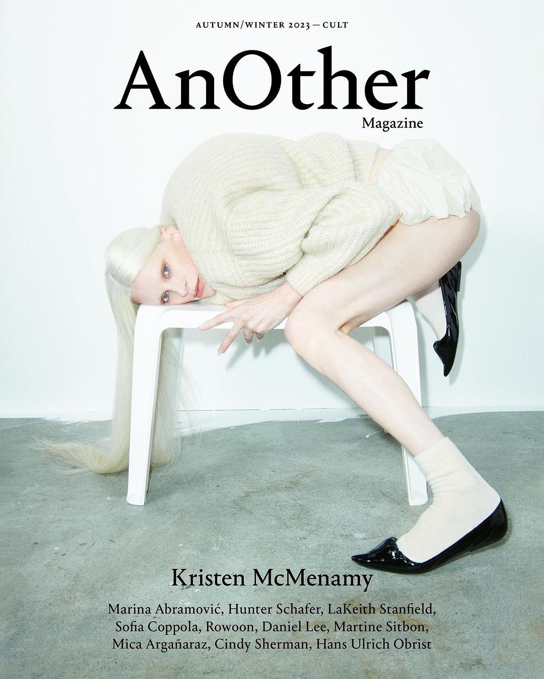 Fashion magazine cover featuring Kristen McMenamy posing on a white chair. The cover features the magazine title 'AnOther'.