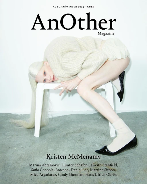 Fashion magazine cover featuring Kristen McMenamy posing on a white chair. The cover features the magazine title 'AnOther'.