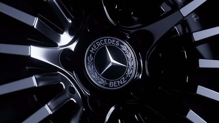 Close-up of a Mercedes-Benz wheel, highlighting the iconic logo in the center of the polished, black car part, creating a sleek auto detail.