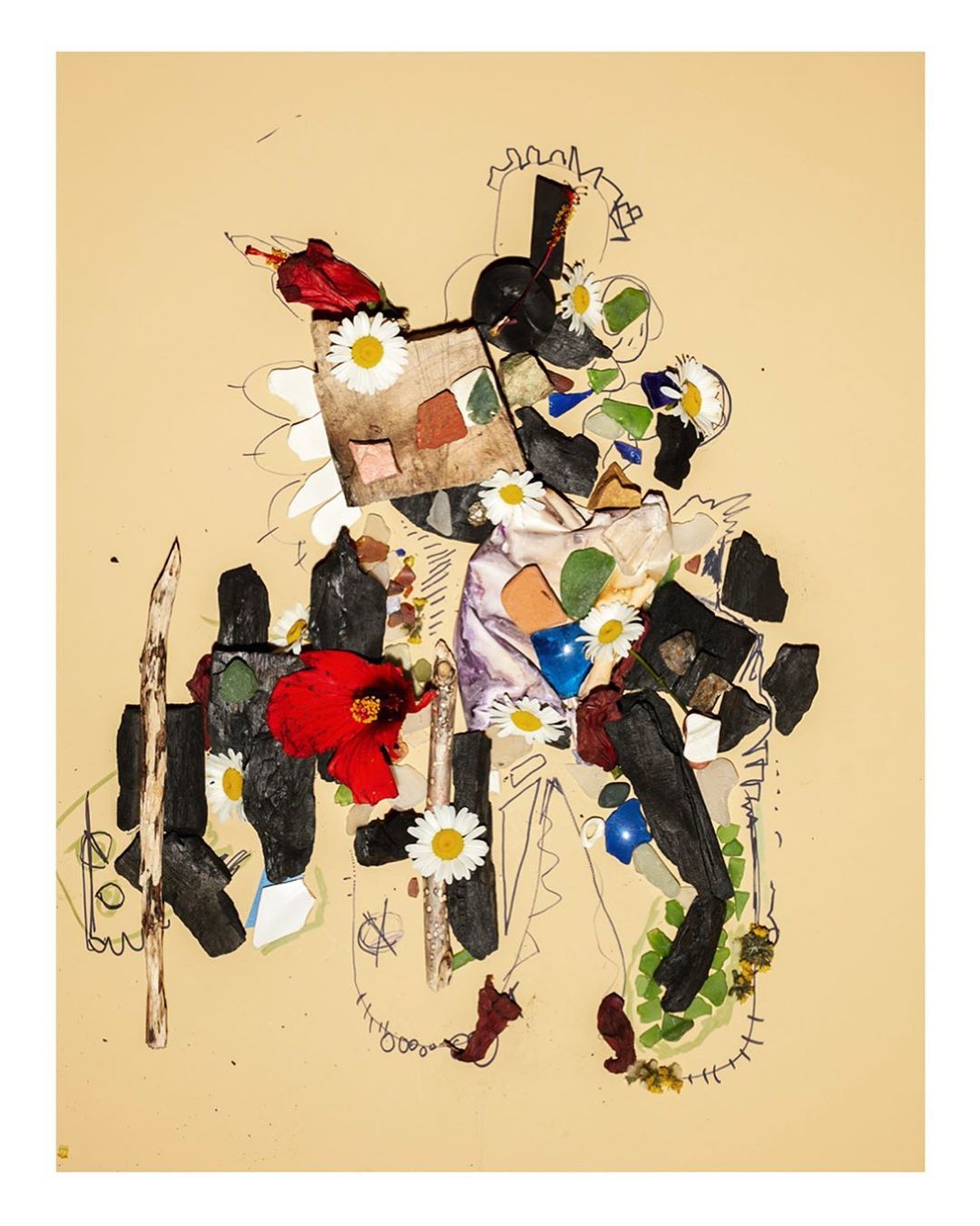 Abstract collage art featuring paper, flowers, and painted elements against a neutral background, blending textures and organic shapes.