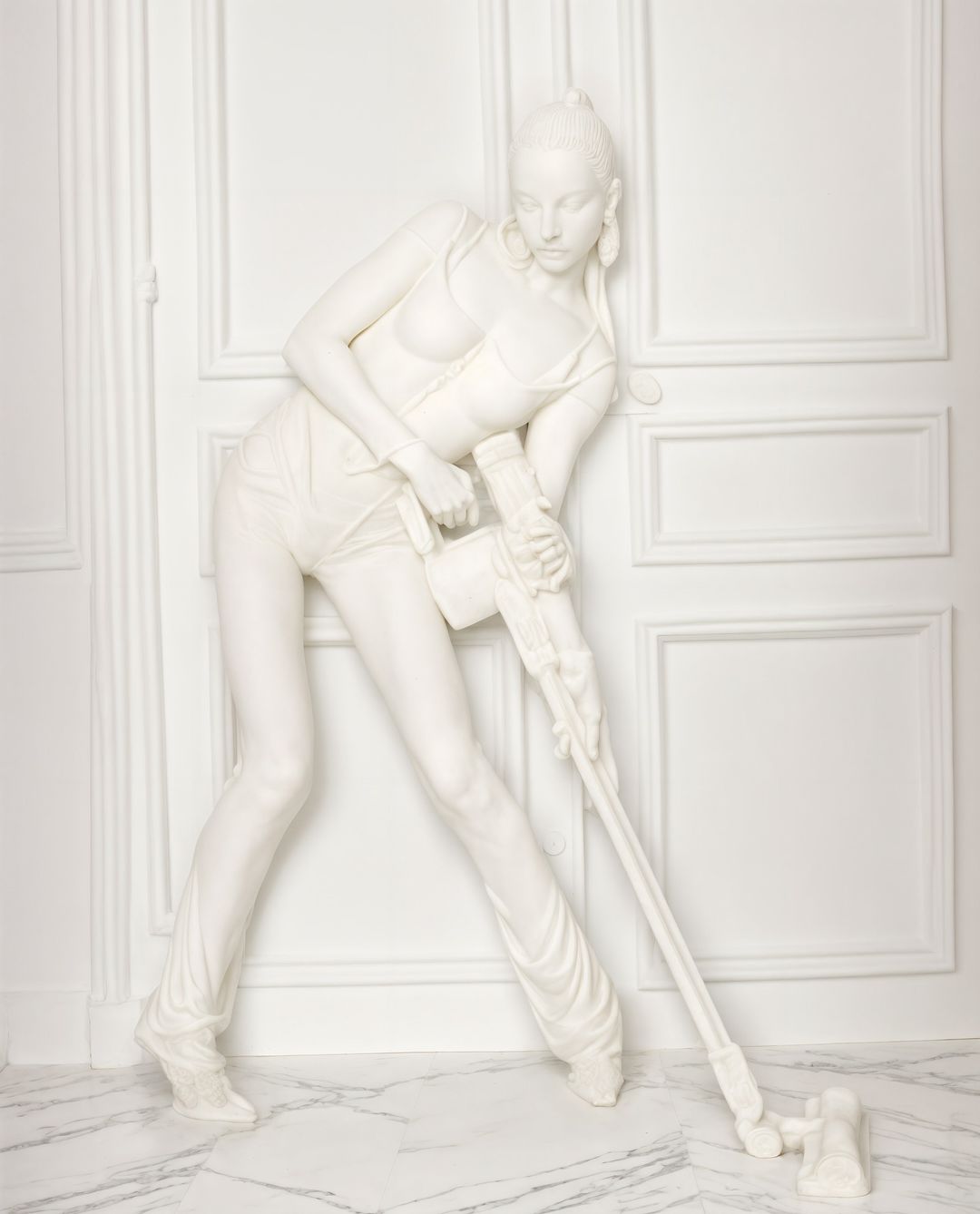 Monochromatic art piece of a woman vacuuming on a marble floor against a textured white wall, presented in a monochromatic white color scheme.
