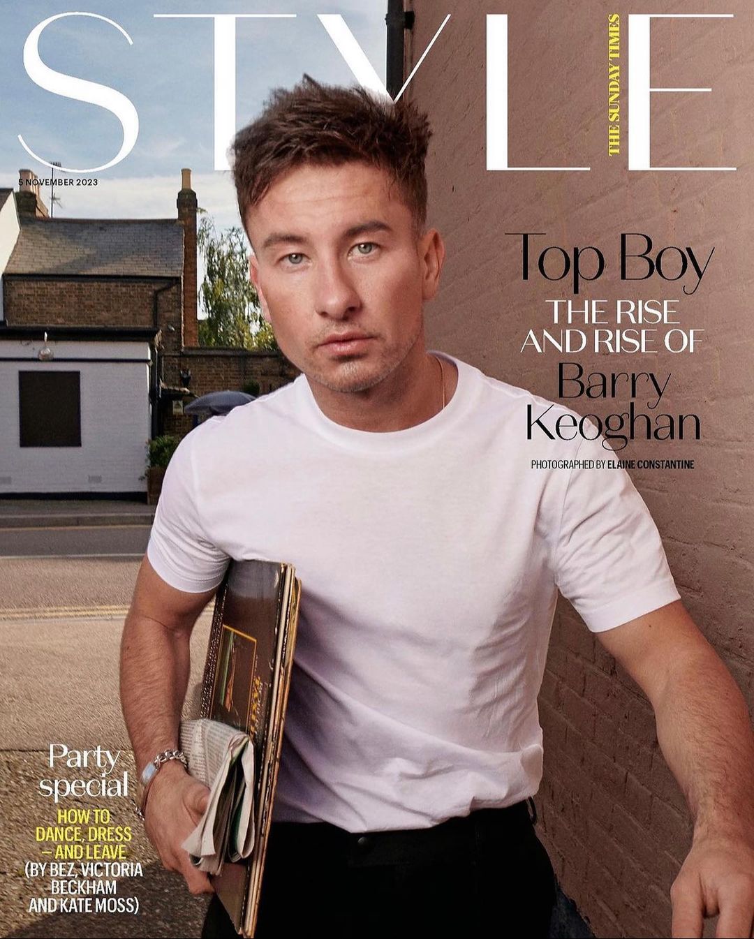 Magazine cover featuring Barry Keoghan in a white t-shirt, holding a record, posing outdoors against a neutral wall and residential street.