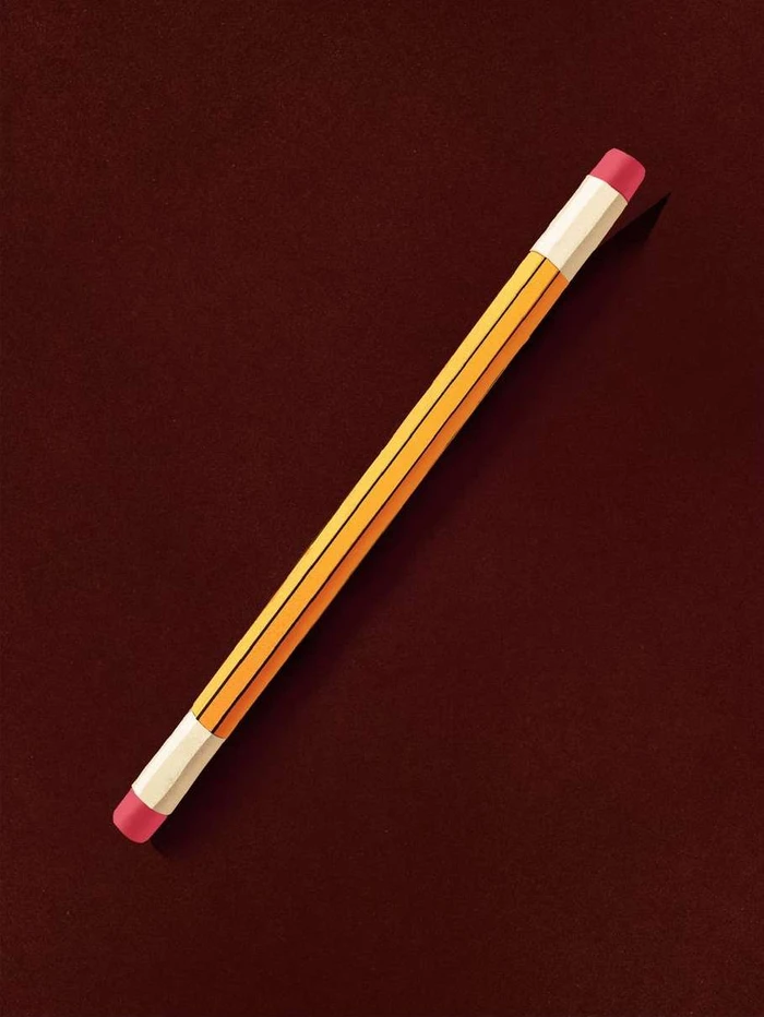 A yellow pencil with pink erasers on both ends resting diagonally on a dark brown textured surface.