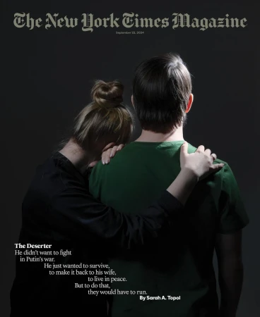 A woman leaning her head against a man's back with her hands on his shoulders in a dark editorial magazine portrait.