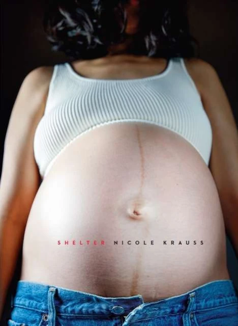 Close-up studio shot of a pregnant woman's bare stomach, wearing a ribbed tank top and open blue jeans, against a dark background.