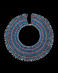 Close-up product shot of an intricate beaded collar necklace featuring alternating bands of blue, pink, and white beads against a black background.