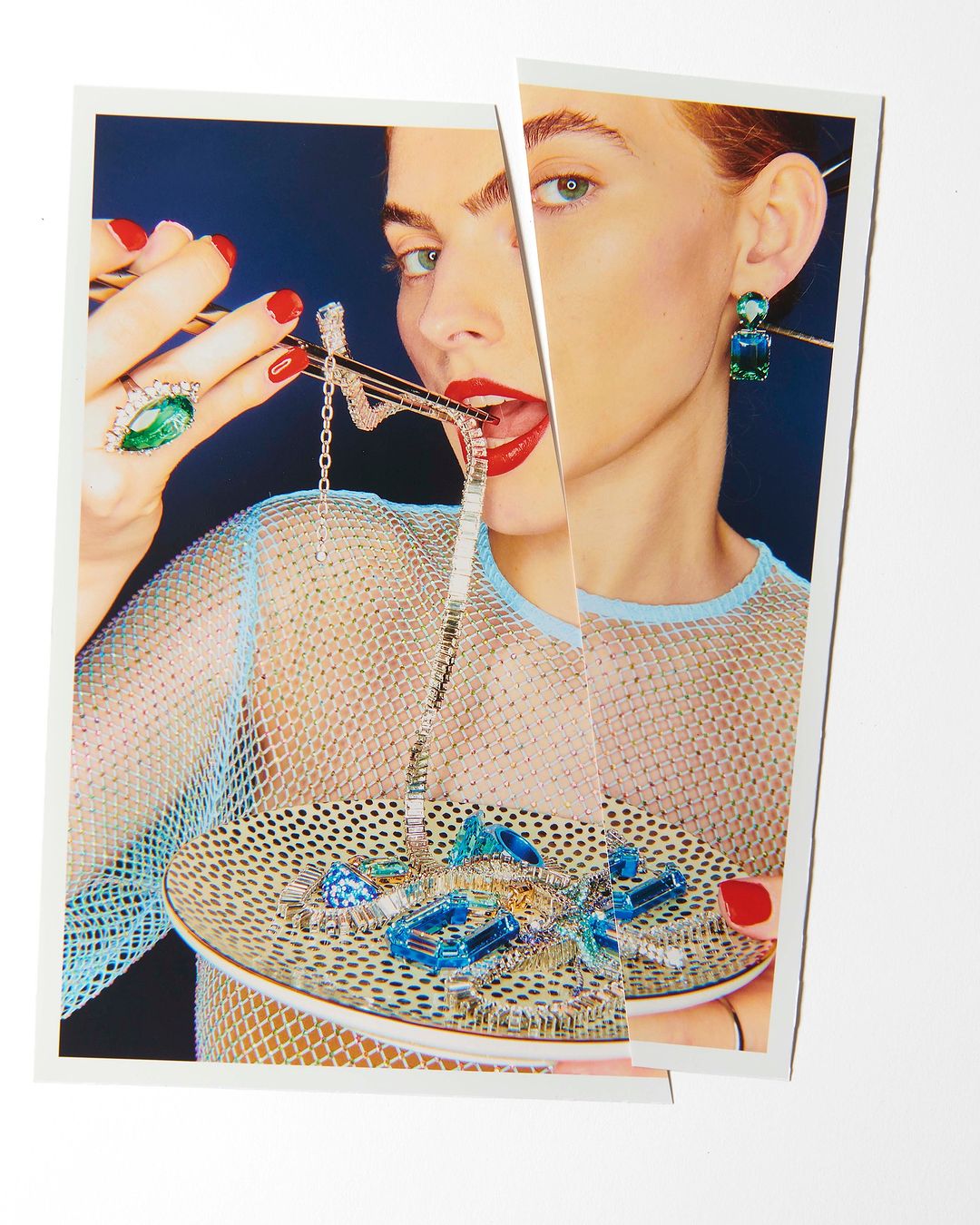 Woman in fishnet top posing with gemstone jewelry on a plate in a fragmented, surreal portrait against a dark blue background.