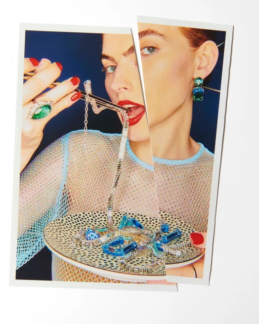 Woman in fishnet top posing with gemstone jewelry on a plate in a fragmented, surreal portrait against a dark blue background.