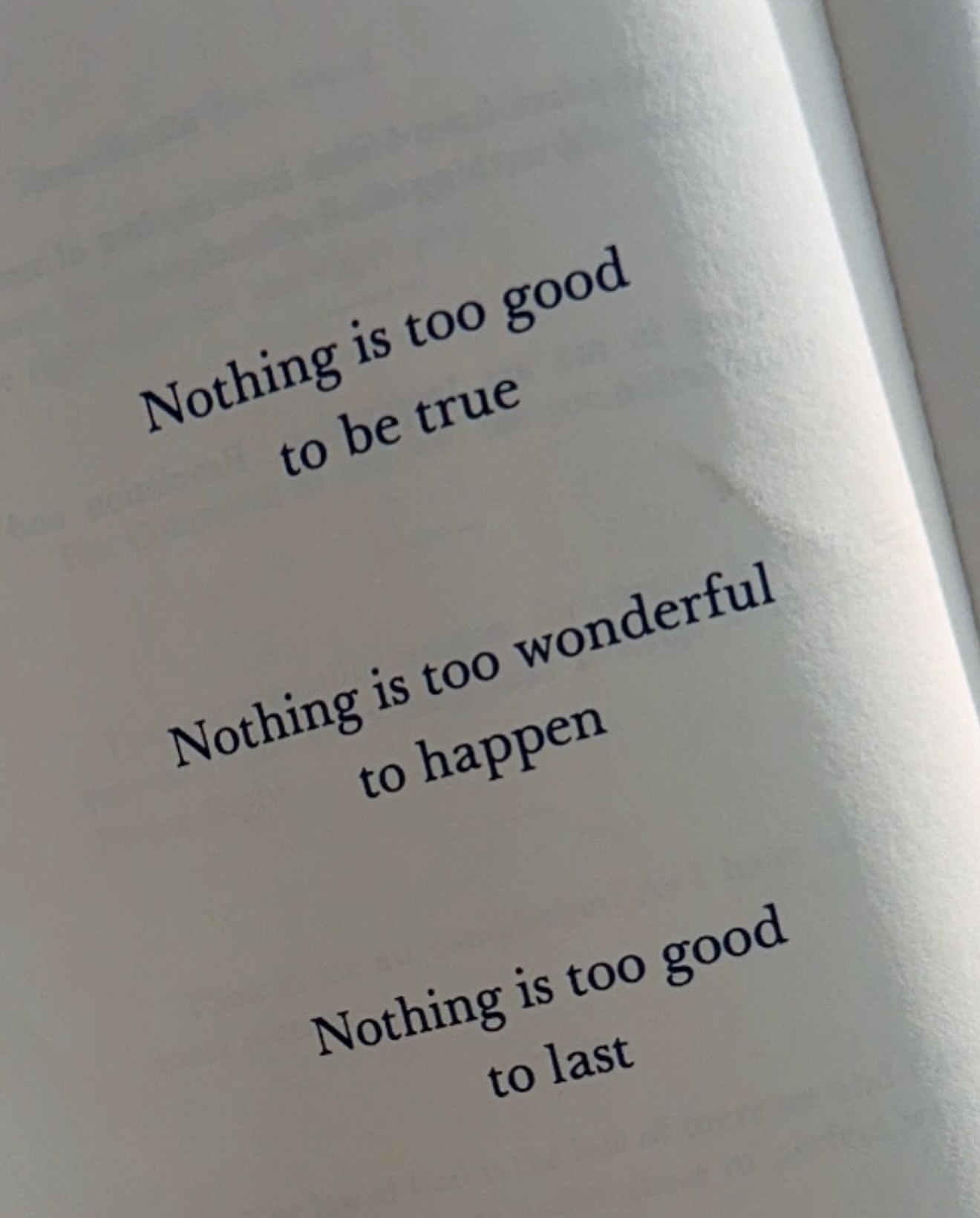 Pages of a book with printed text "Nothing is too good to be true," "Nothing is too wonderful to happen," and "Nothing is too good to last."
