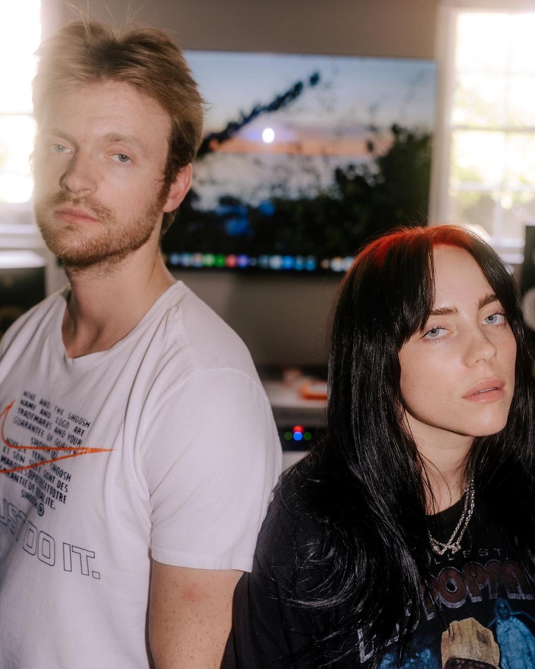Billie Eilish and Finneas O'Connell posing indoors for a portrait photograph by Elizabeth Weinberg in New York.